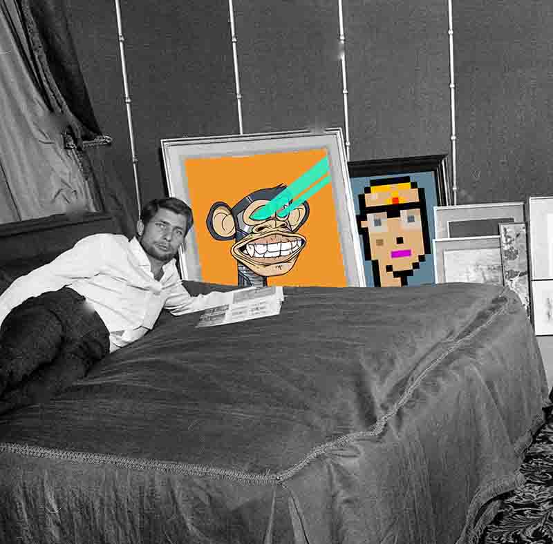 Photo of Gunther Sachs' bedroom with various NFT art pieces. The bed is covered in a dark gray comforter, the art pieces of a CryptoPunk 3100 and Bored Ape 1 are propped up against the wall.