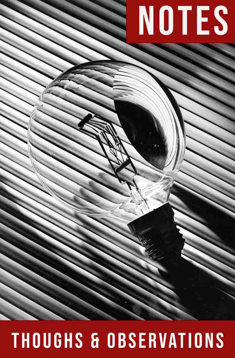 notes-thoughts-observations-cover-1 A stark, black and white close-up shot of a notebook features a clear, old-fashioned incandescent light bulb resting on a diagonally striped surface.