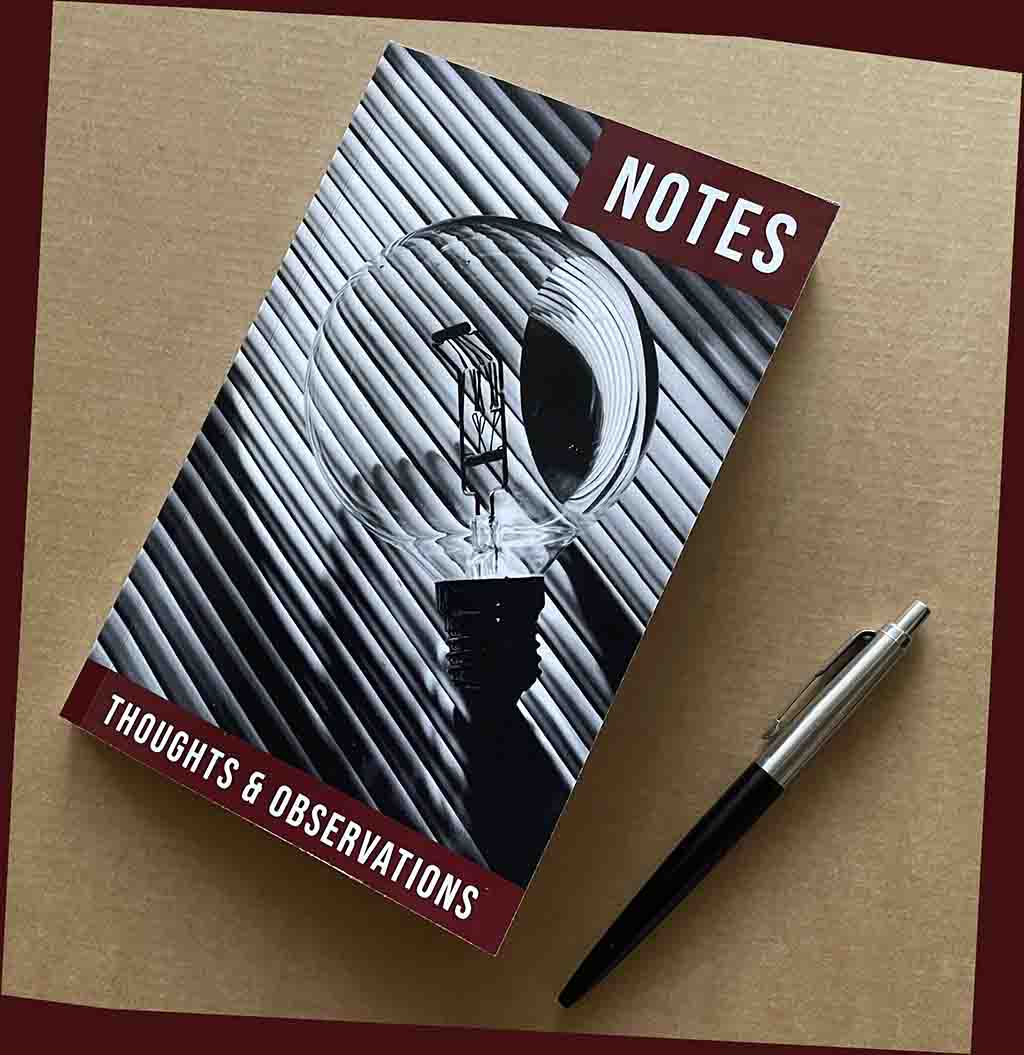 Guide to Notebooks A slightly angled overhead shot captures a notebook with a distinctive cover design, placed on a warm brown, cardboard, surface.