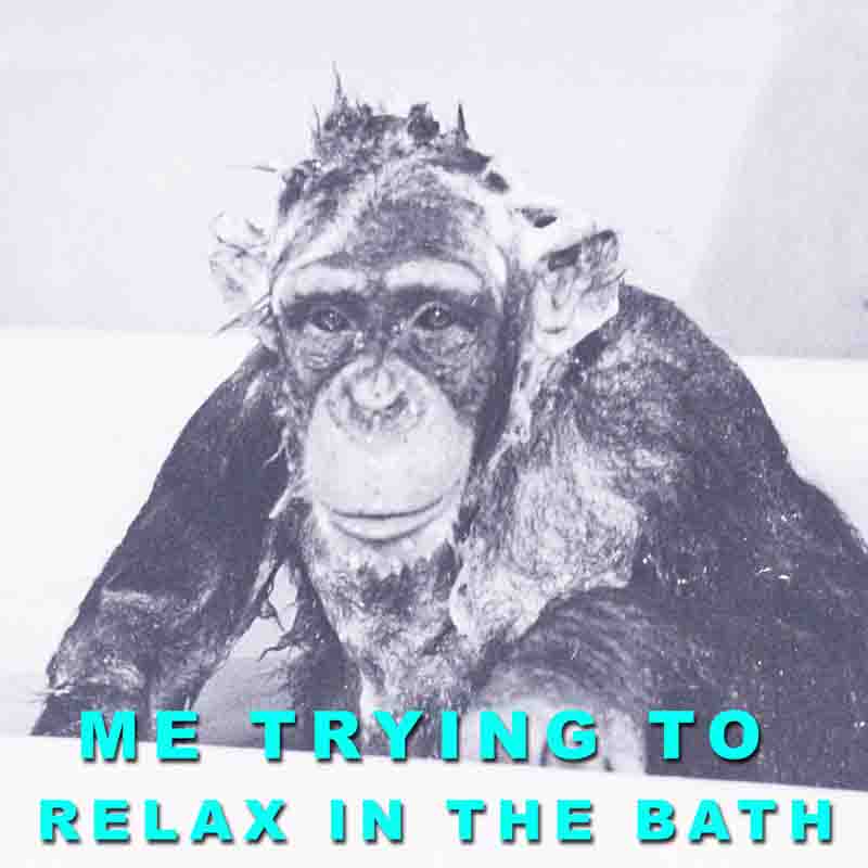 A monkey in a bathtub, attempting to unwind, with the words me trying to relax in the bath.